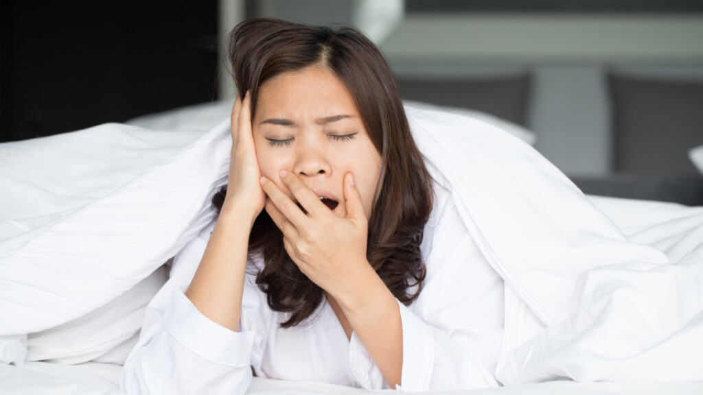 Woman yawning due to insomnia from detoxing.